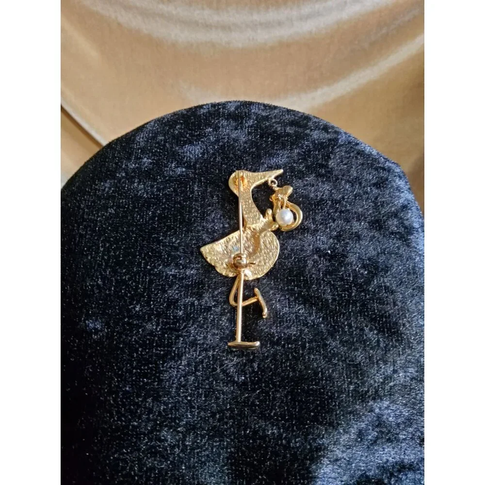 vintage gold tone/black bowtie stork with faux pearl dangling baby bundle brooch